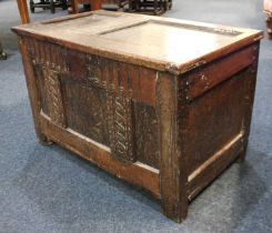 A 17th century small oak coffer with carved panel front, raised on block supports, 84cm (a/f)