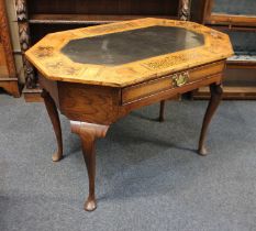 A seaweed marquetry inlaid centre table, the compressed octagonal top with inset slate panel over