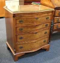 A 20th century walnut veneered serpentine-front chest of four drawers with brushing slide, on