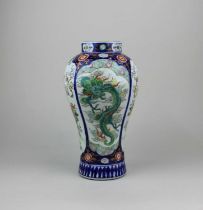 A Chinese porcelain baluster vase decorated with panels of green dragons and birds amongst