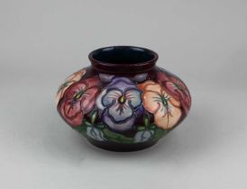 A Moorcroft vase decorated in the ‘Pansy’ pattern of squat bulbous form, 12cm