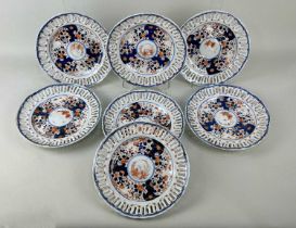 A set of seven 19th century Japanese Imari porcelain ribbon plates having pierced rims, impressed