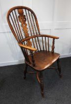 A Windsor armchair with pierced back splat, on turned legs with oxbow stretchers