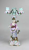 A Meissen porcelain figural three light candelabra modelled as a lady holding an array of fruits