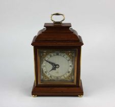 An Elliott mahogany cased mantle clock, the silvered chapter ring with Roman numerals and gilt