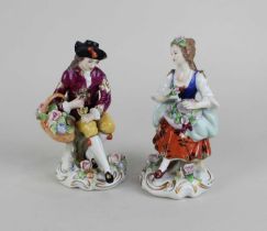 A pair of Sitzendorf porcelain figures holding flowers 13cm high