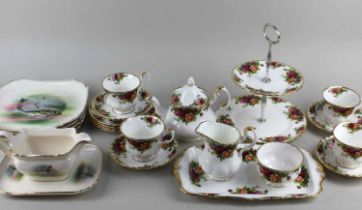 A Royal Albert Old Country Roses porcelain tea service comprising small teapot 16cm high, milk