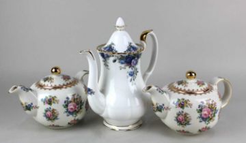 Two Royal Albert porcelain 'Lady Carlyle' pattern teapots and a Royal Albert 'Midnight Rose'