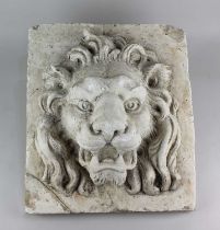 A decorative relief moulded plaster plaque depicting a lion mask on a square base and clipboard