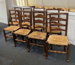 A matched set of eight oak ladderback chairs with rush seats (a/f)