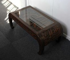 A Chinese carved opium coffee table with top depicting figures in a courtyard, deeply carved under
