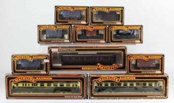 A collection of boxed Mainline Railways OO gauge model railway coaches, brake vans and wagons, to