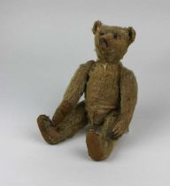 An early 20th century Steiff teddy bear with button to the ear 23cm, gifted to the current owner