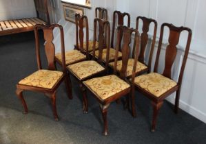 A matched set of eight dining chairs with vase back splats, drop in upholstered seats, on cabriole