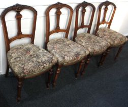 A set of four Victorian dining room chairs with carved baluster back splats, tapestry upholstered