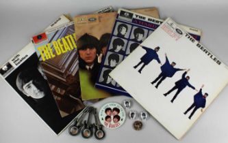 A collection of eight 1960's Beatles badges to include four black and white badges and three in