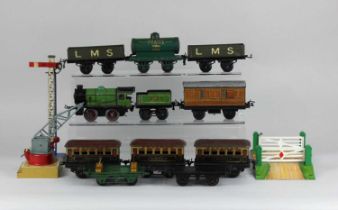 A collection of Hornby 0 gauge tinplate clockwork model railway to include locomotive and tender,