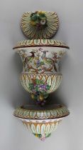 A Spanish pottery wall fountain and basin decorated with birds, flowers and fruit (a/f)