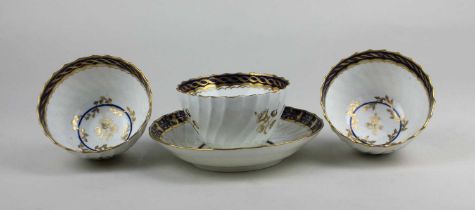 Three Flight period Worcester porcelain tea bowls wrythern form with blue and gilt decoration,