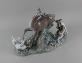 A Lladro porcelain figure group 'Fierce Pursuit' of a kudu and dogs 30cm high