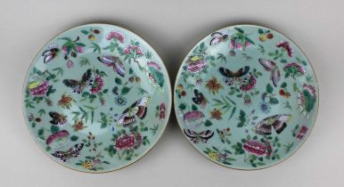 A pair of Chinese celadon ground famille rose plates decorated with butterflies amongst floral and