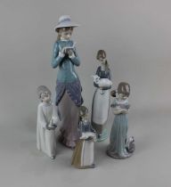 Five Lladro porcelain figures of young ladies to include a lady wearing a straw hat reading a book