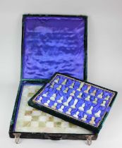 An onyx chess set and board in fitted velvet case