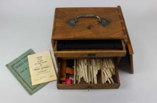 A mah-jong set with resin counters and bone markers in fitted wooden case (a/f)