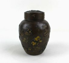 A Japanese bronze jar and cover with inner pierced cover, decorated in light relief with gilt