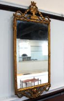 A gilt rectangular wall mirror with pierced urn and swag surmount