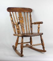 A child's Windsor open arm rocking chair with spindle and pierced splat back