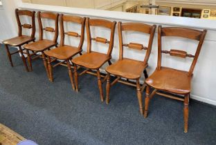 A set of six Victorian dining chairs with tablet bar backs and solid seats, on baluster legs