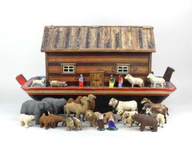 A painted wooden Noah's ark 62cm long, together with a collection of over twenty cloth and hide