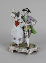 A porcelain figure group of a gentleman and a lady in dancing pose, faint mark to base 18cm high