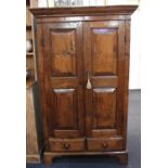 A rustic oak cabinet with two panel doors enclosing two shelves, two drawers below, on bracket