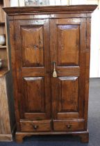 A rustic oak cabinet with two panel doors enclosing two shelves, two drawers below, on bracket