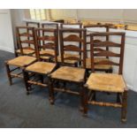 A matched set of eight oak ladderback chairs with rush seats (a/f)