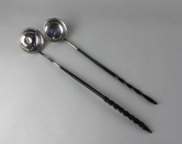 Two white metal George III brandy ladles each with a coin inset circular bowl, one coin dated 1711