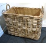 A large rectangular wicker two handled basket on castors 66cm high, 73cm wide