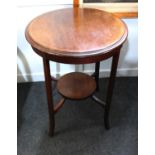 An Edwardian inlaid mahogany circular two tier side table, c.1900/1910, raised on elegant outswept