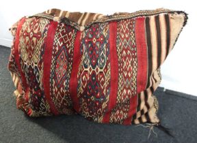 An early 20th century Persian saddle bag, decorated with bands of geometric motifs on a