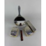 A pair of Elizabeth II silver topped clothes brushes and a matching comb, maker Garrard & Co Ltd,