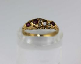 An 18ct gold ring mounted with three cushion shaped rubies and with three variously cut diamonds one