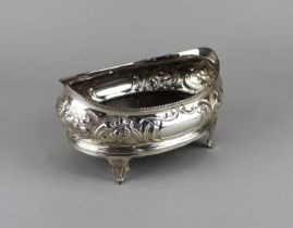 A George III silver oval dish embossed with fruit and foliage on sprayed bracket feet with later