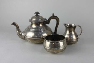 A George V silver three piece tea set of teapot, milk jug and sugar bowl, circular squat form with