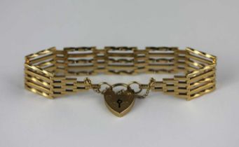 A 9ct gold bar and twisted bar link gate bracelet on a 9ct gold heart shaped padlock clasp with