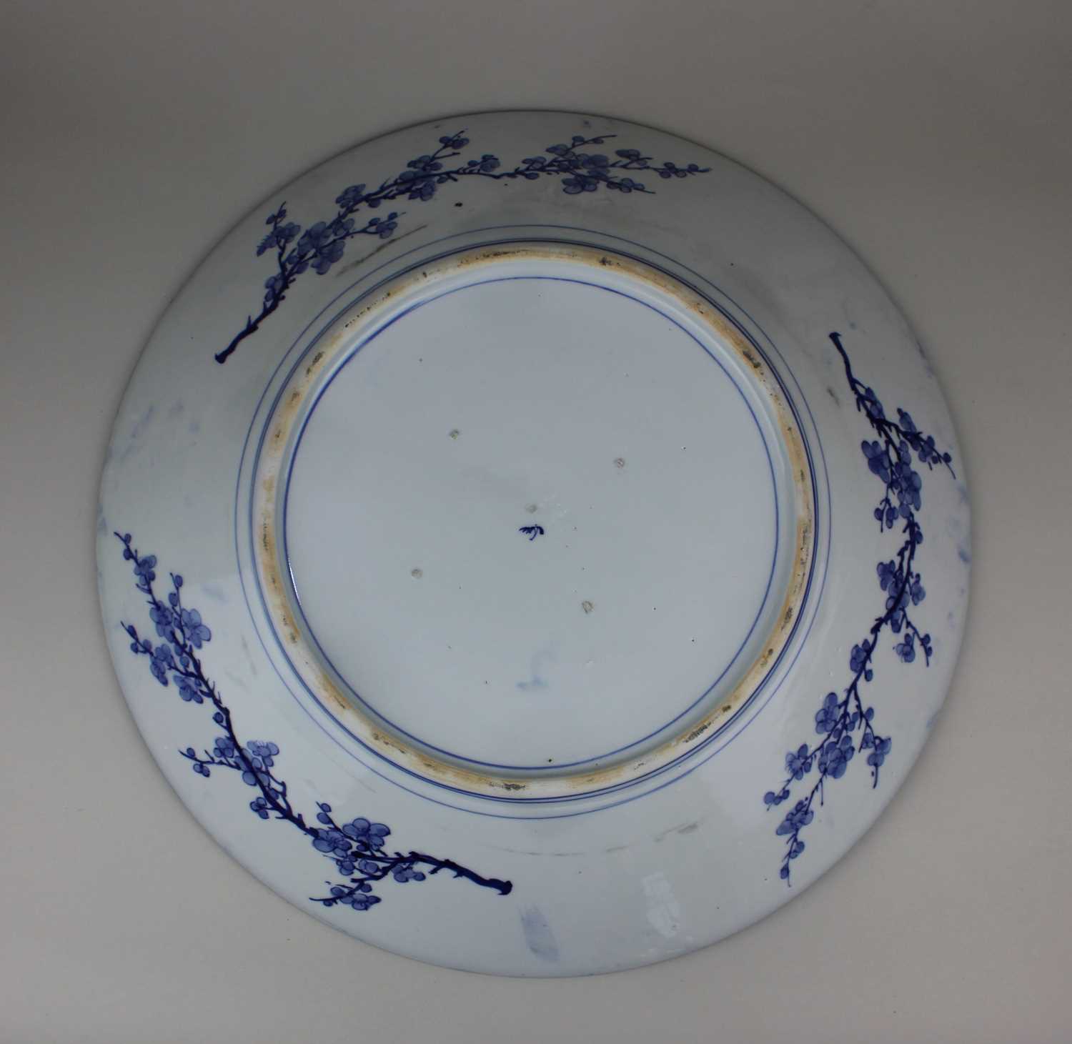 A Japanese blue and white porcelain charger decorated with a bird of prey amongst flowers and - Image 2 of 2