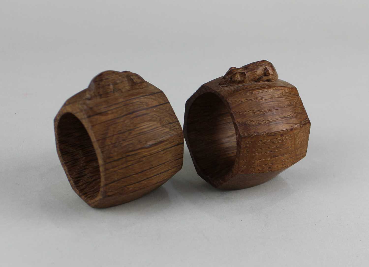 Two Robert Thompson 'Mouseman' oak napkin rings, both carved with mouse signature
