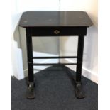 A Victorian ebonised sewing table rectangular cut cornered top above a fitted drawer on turned end