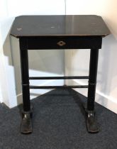 A Victorian ebonised sewing table rectangular cut cornered top above a fitted drawer on turned end